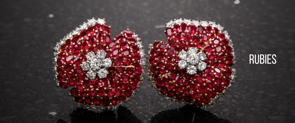Luxury ruby earrings from Dover Jewelry, featuring vibrant red rubies set in intricate floral designs with sparkling diamonds, showcasing elegance and craftsmanship